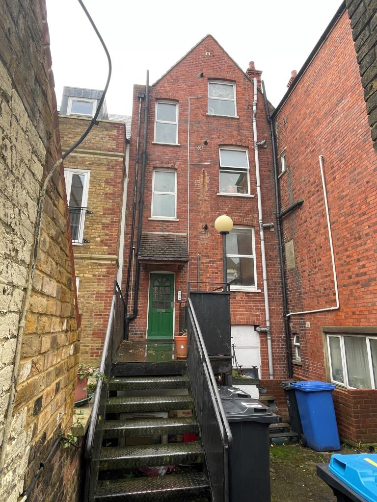 Lot: 38 - PUB AND THREE FLATS FOR INVESTMENT - Rear of property with residential access